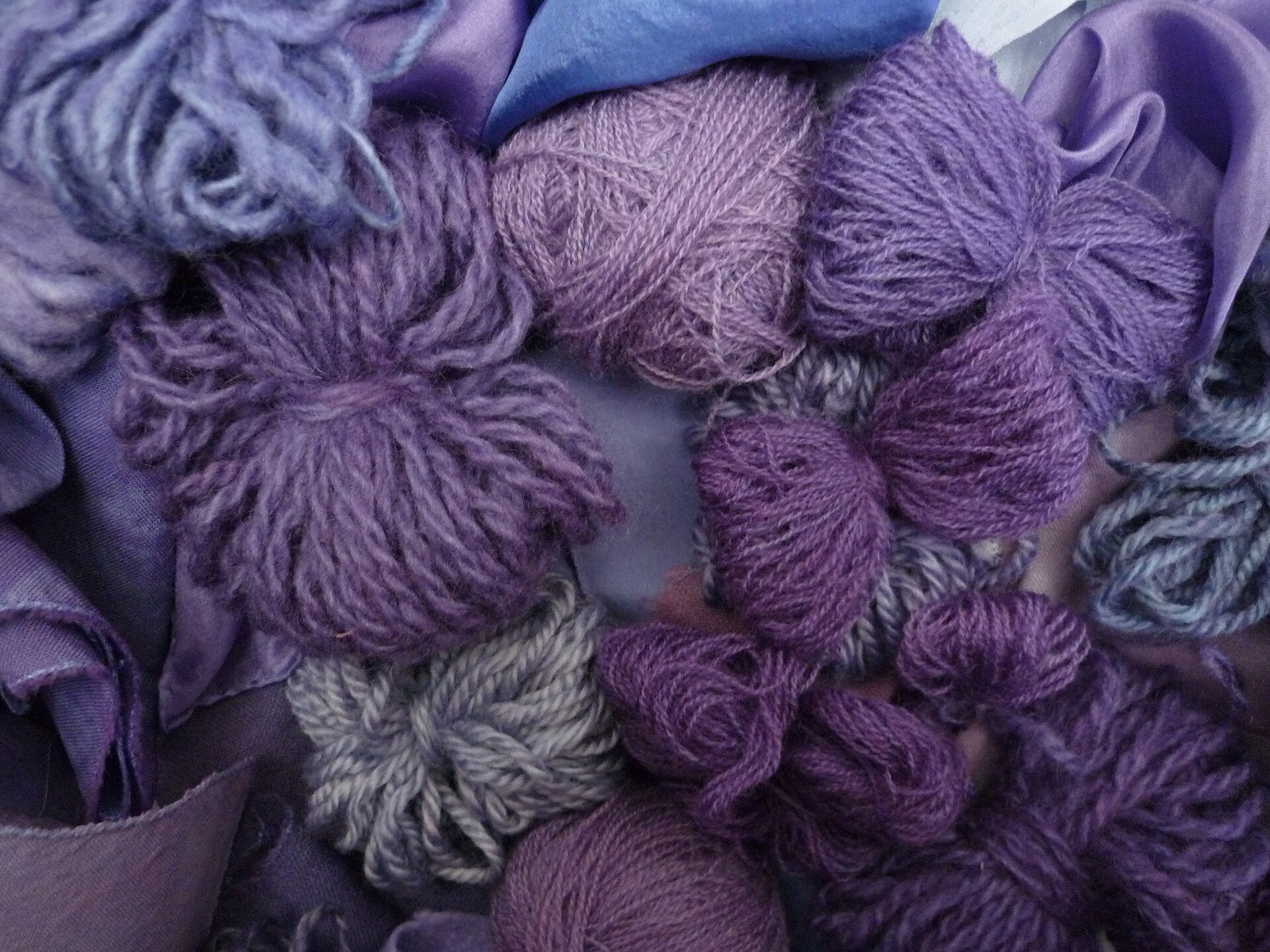 Skeins of wool dyed deep purple, the color of mauveine and its natural predecessor Tyrian purple